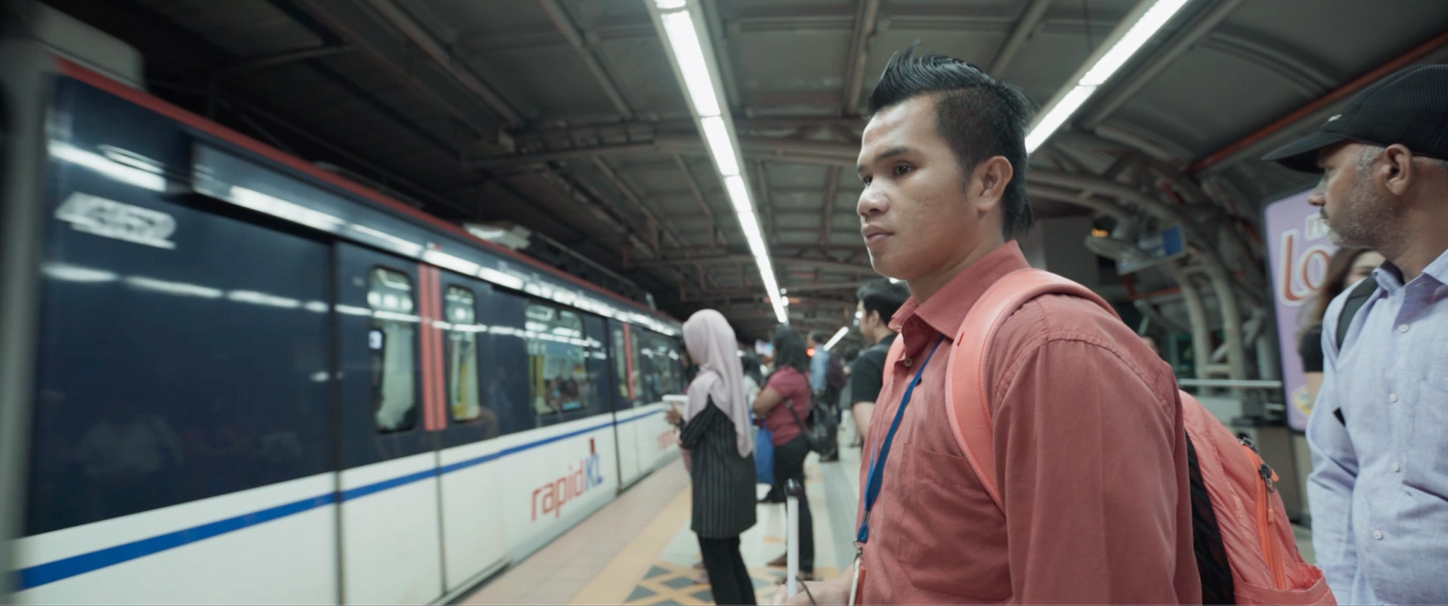 Blind footballer Rollen is waiting at the platform as his train arrives.